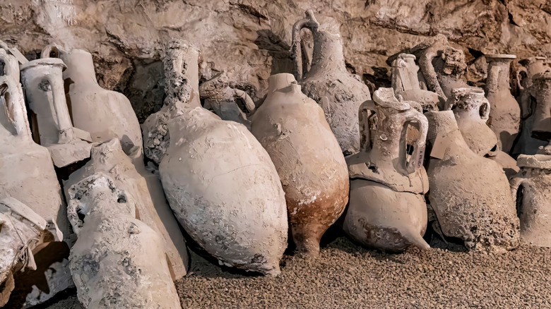 A pile of Ancient Roman amphoras sitting in a cave.