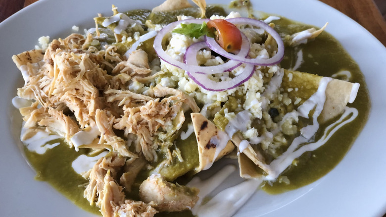 Green chilaquiles with shredded chicken and cheese