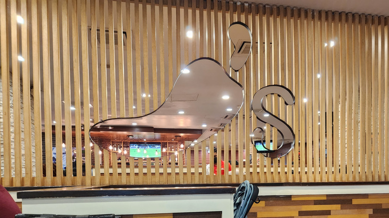 interior of chili's restaurant featuring chili's logo cutout from privacy screen