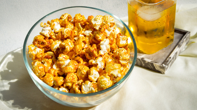 caramel corn in bowl by drink