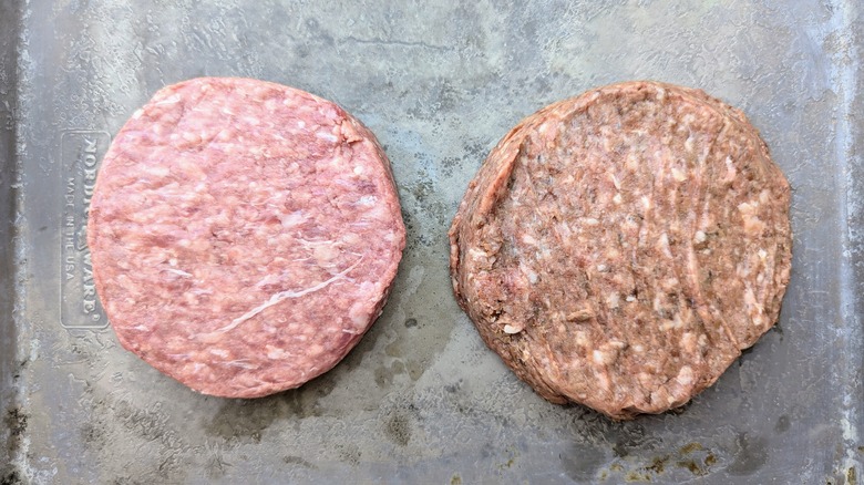 raw burger patties on tray