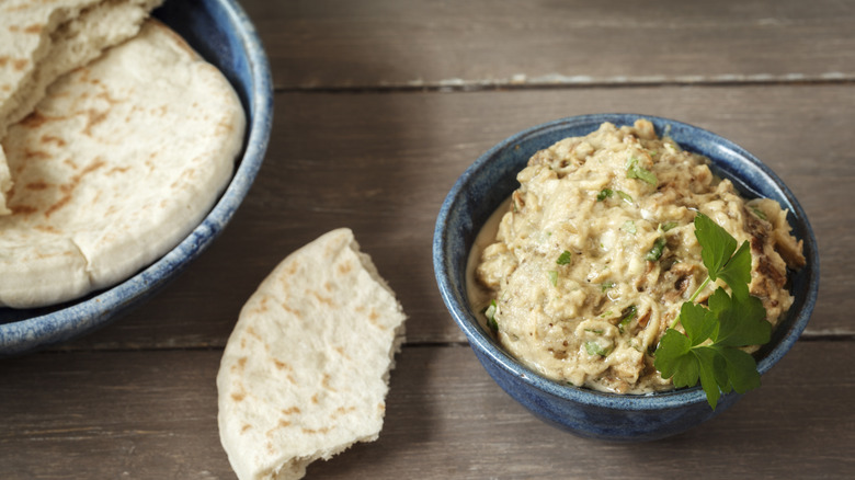 A bowl of fresh baba ganoush with pita bread