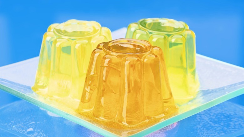 Three yellow gelatin molds on a plate