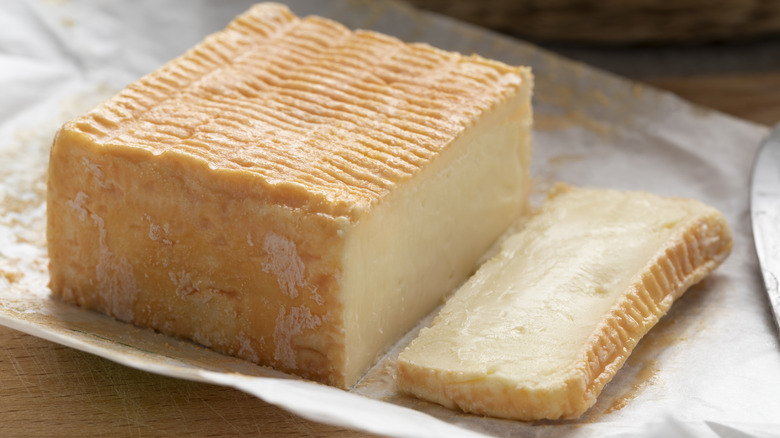 Close up of a block of Limburger cheese on wax paper