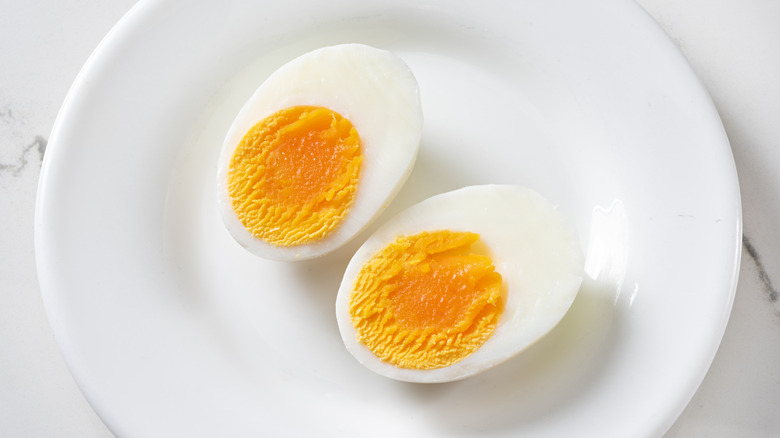 Sliced hard-boiled eggs on a white plate