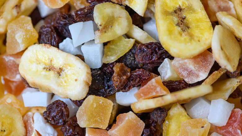 A close up photo of dried fruit, including raisins, coconut, and bananas