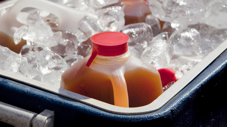 apple cider in a cooler with ice