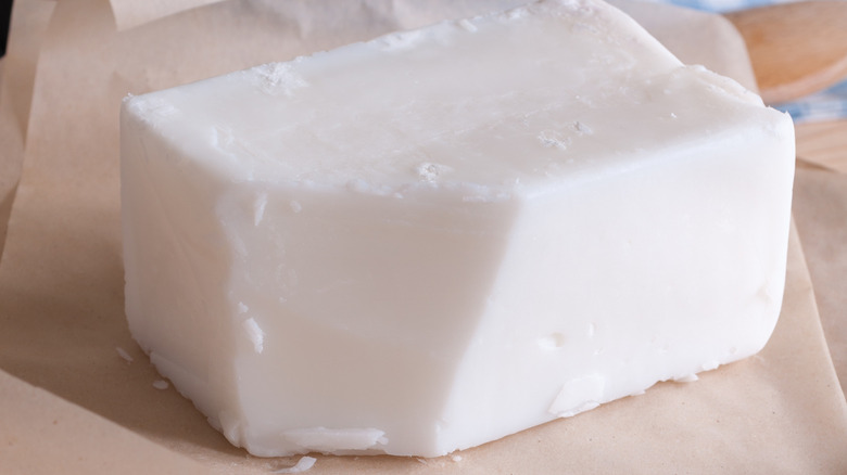 A block of beef tallow on parchment paper