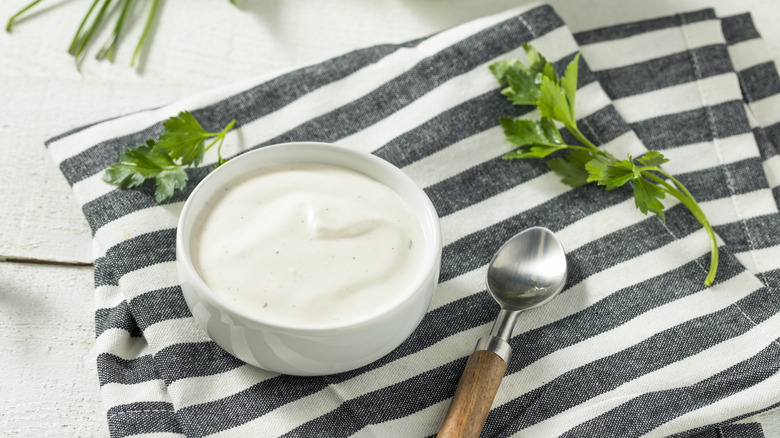 a bowl of ranch with a spoon