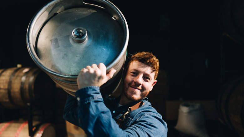 Person holding keg