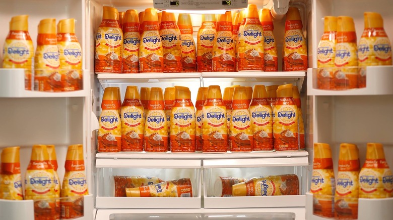 a fridge stocked with many bottles of creamer