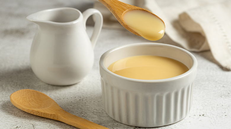 a ramekin of evaporated milk with pitcher