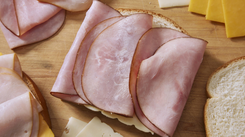 Open-faced deli meat sandwiches on white bread