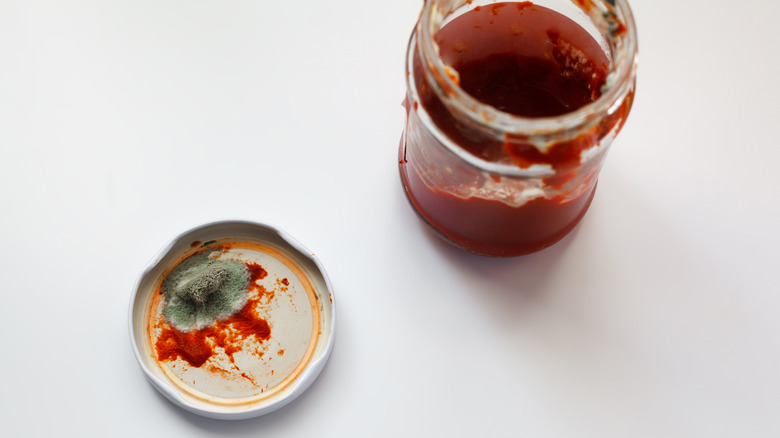 An opened jar with mold