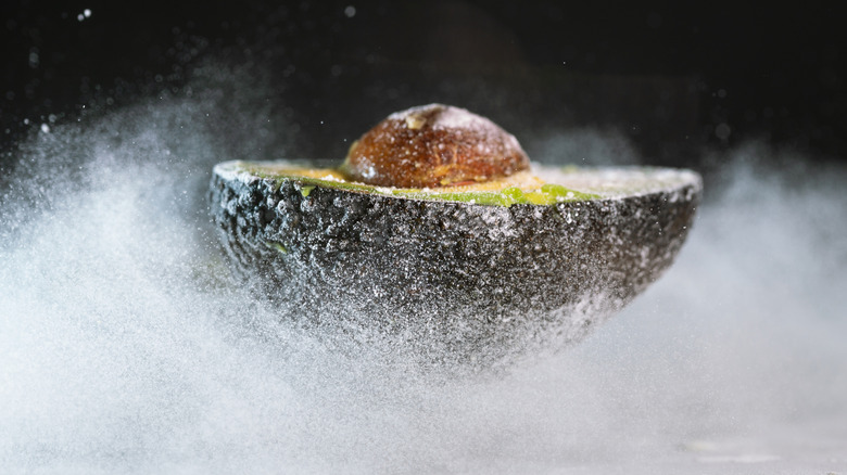 Frozen half avocado covered in ice crystals