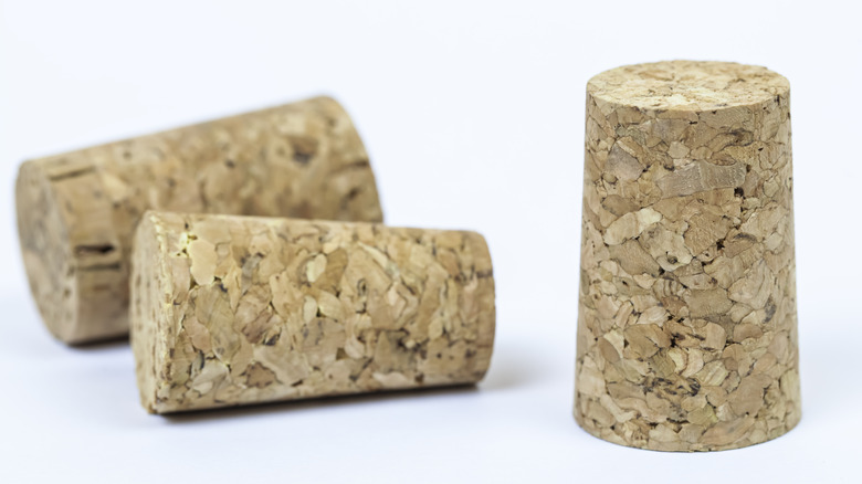 three corks on a white background