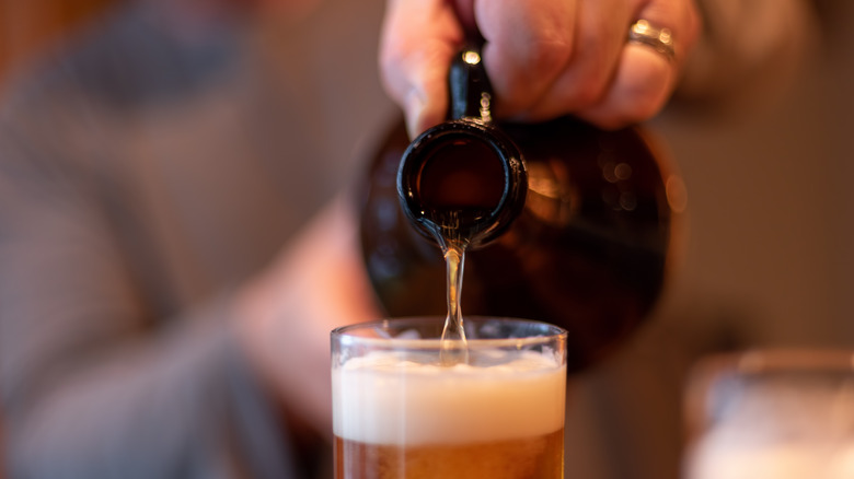 beer being poured from a growler into a glass