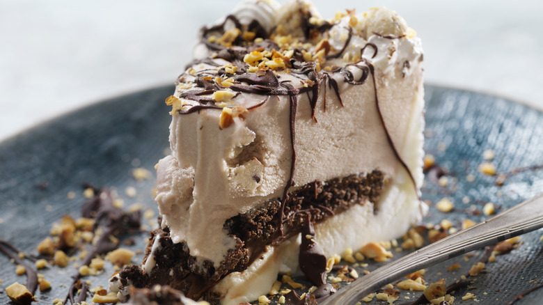 an ice cream cake with nut toppings