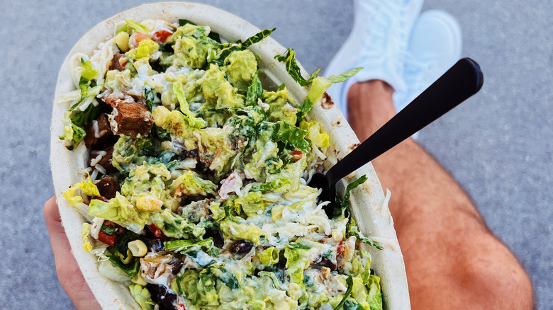 Man holding Chipotle food bowl