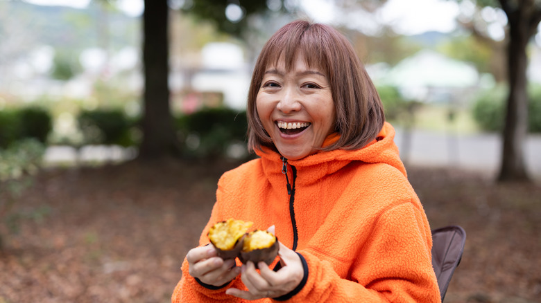 Woman with baked sweet potato