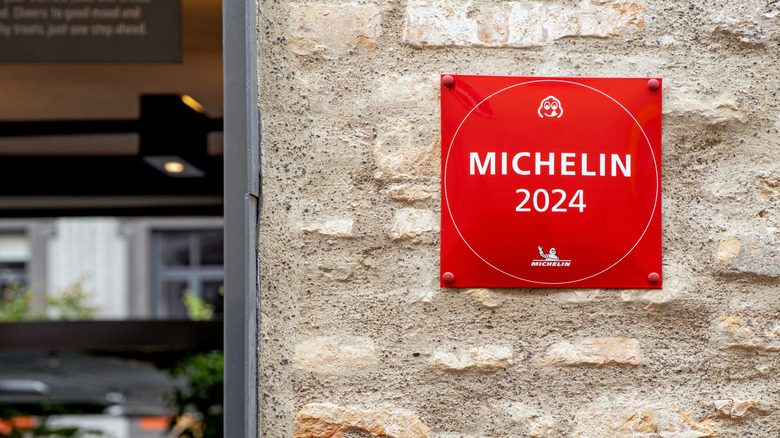 Red and white Michelin star plaque on brick wall