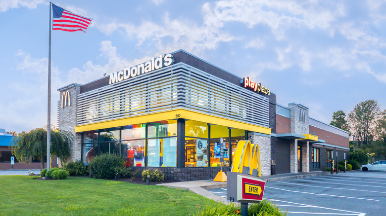 A McDonald's building with an American flag in front