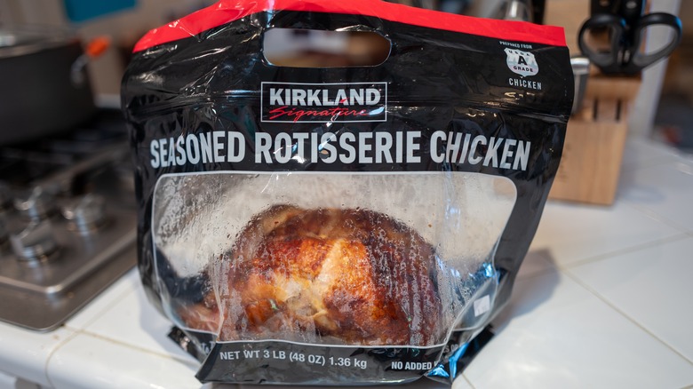 A Costco rotisserie chicken is shown on a kitchen counter