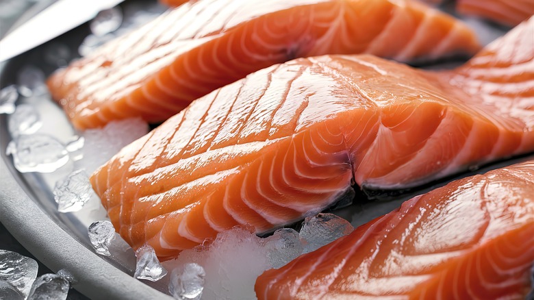 raw salmon resting on ice