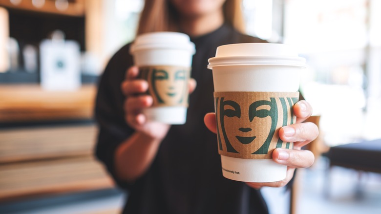 two Starbucks paper cups