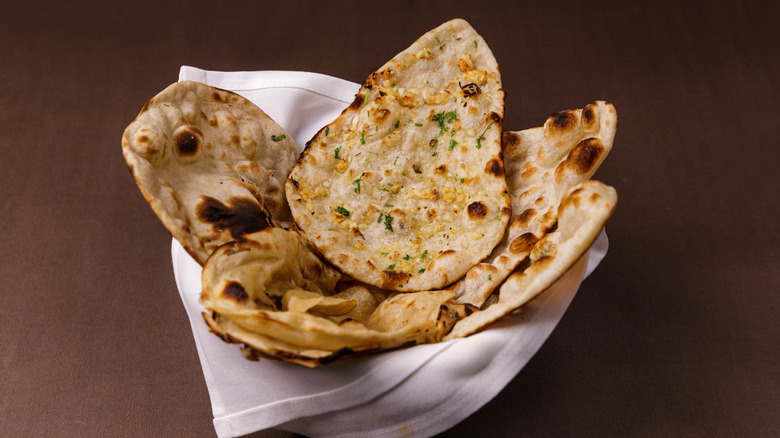 assorted flatbreads inside a cloth towel or napkin