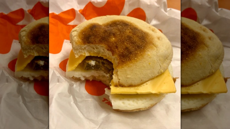 A Dunkin' breakfast sandwich with a bite missing