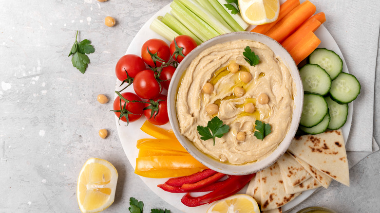 bowl of hummus on a platter of raw vegetables