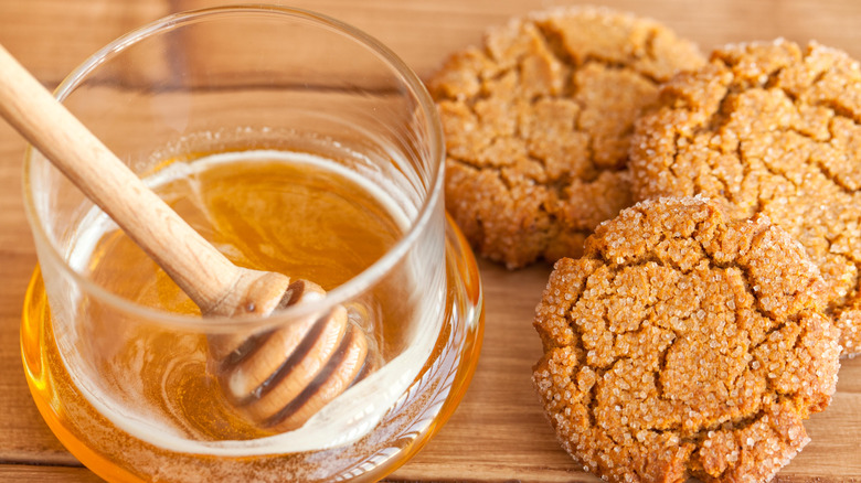 a jar of honey with sugared cookies