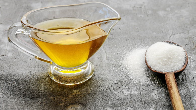 a serving dish of honey versus spoon of white sugar