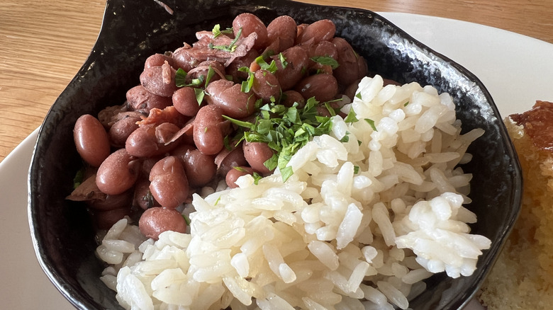 Plate of beans and rice served in a small cast iron skillet