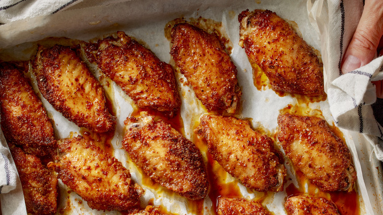 Baked chicken wings on parchment paper-lined sheet pan