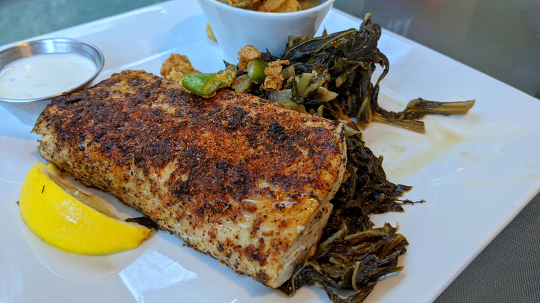 Plate of blackened Mahi Mahi with collard greens and fried okra