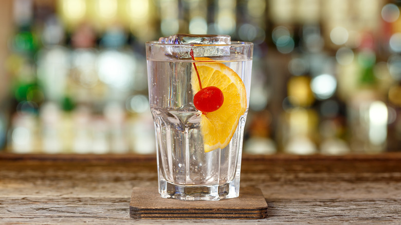 A drink in a Collins glass served with a Collins spear.