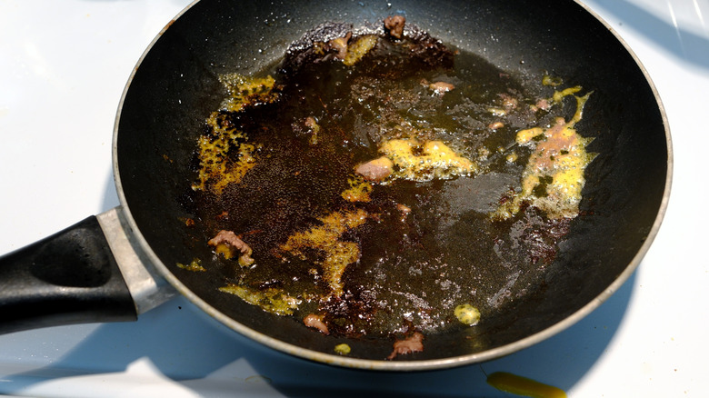 Melted cheese stuck on a pan with grease