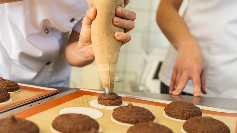 Piping dessert filling onto thin wafers