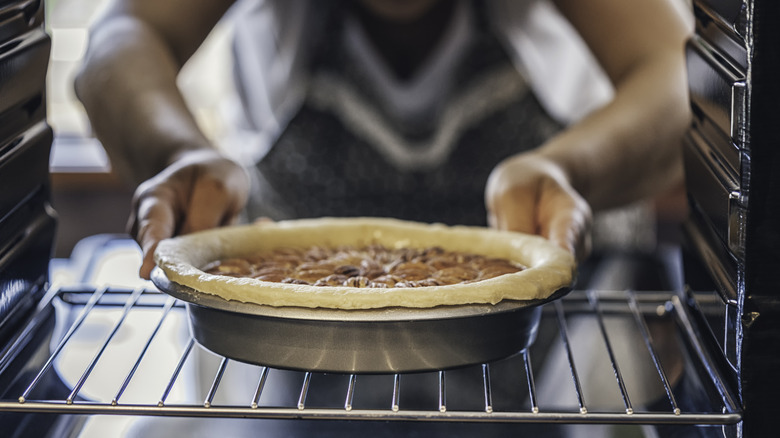 filled pie baking in oven