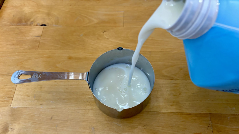 Milk poured in measuring cup