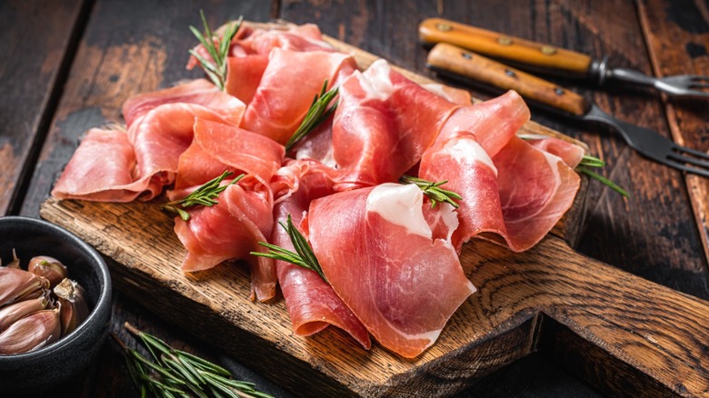 Jamón Serrano on a wooden cutting board.