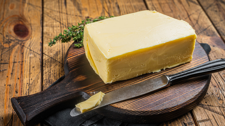 Block of butter on a wooden board