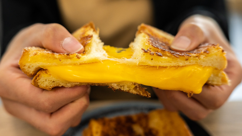 Woman holding a grilled cheese