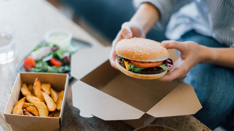 A person eating fast food at a table