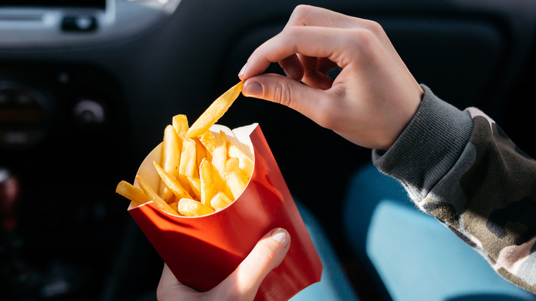 Eating French fries in a car