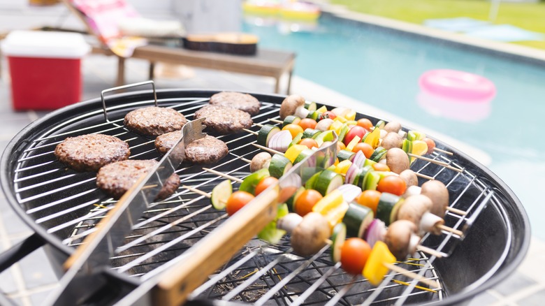 burgers and vegetables on grill