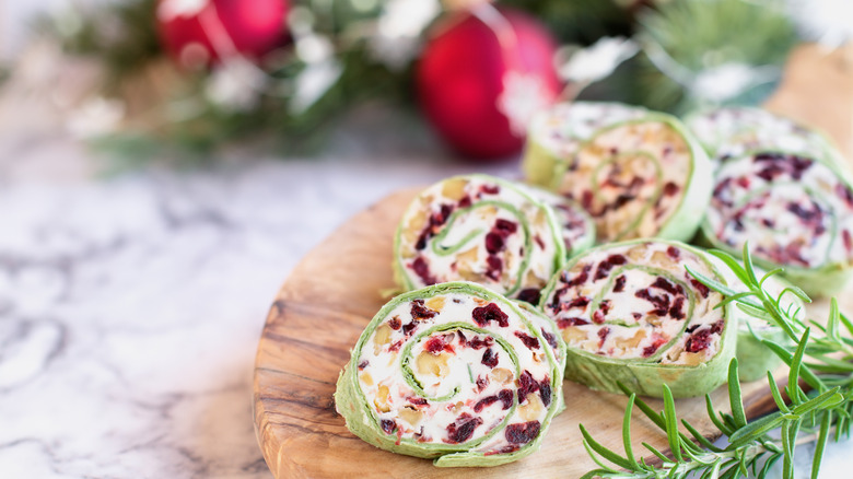 cranberry pinwheels made with cream cheese, dried cranberries, walnuts, goats cheese and rosemary ready for the holidays.