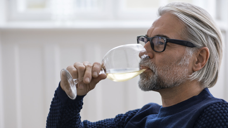 A man drinking some wine.